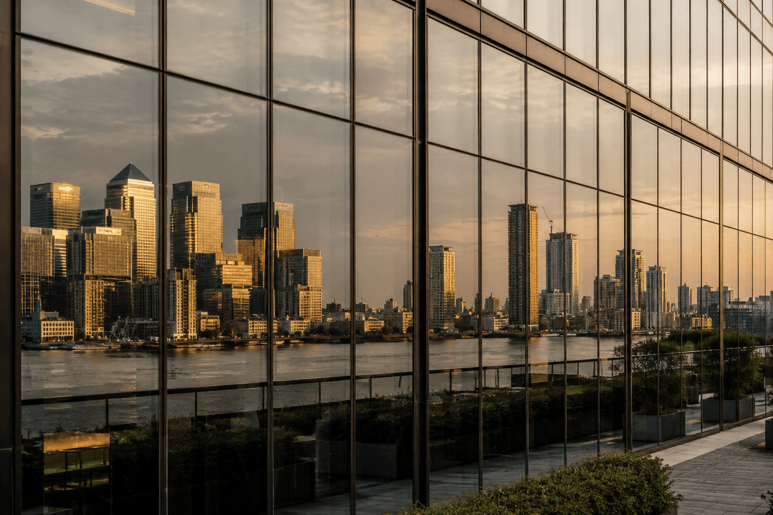 Dual city skylines reflected in glass — institutional partnerships